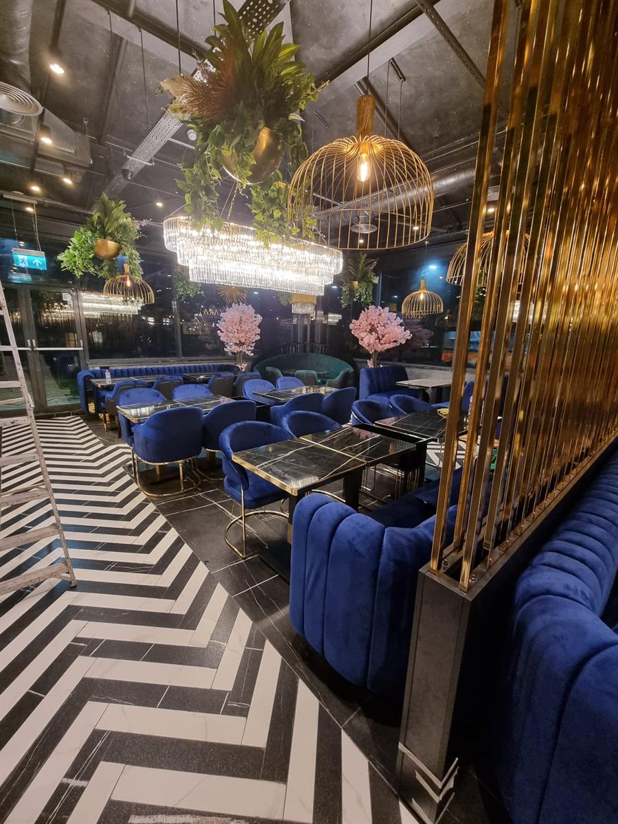 Restaurant lounge fit-out in Milton Keynes — booth seating and feature lighting installed
